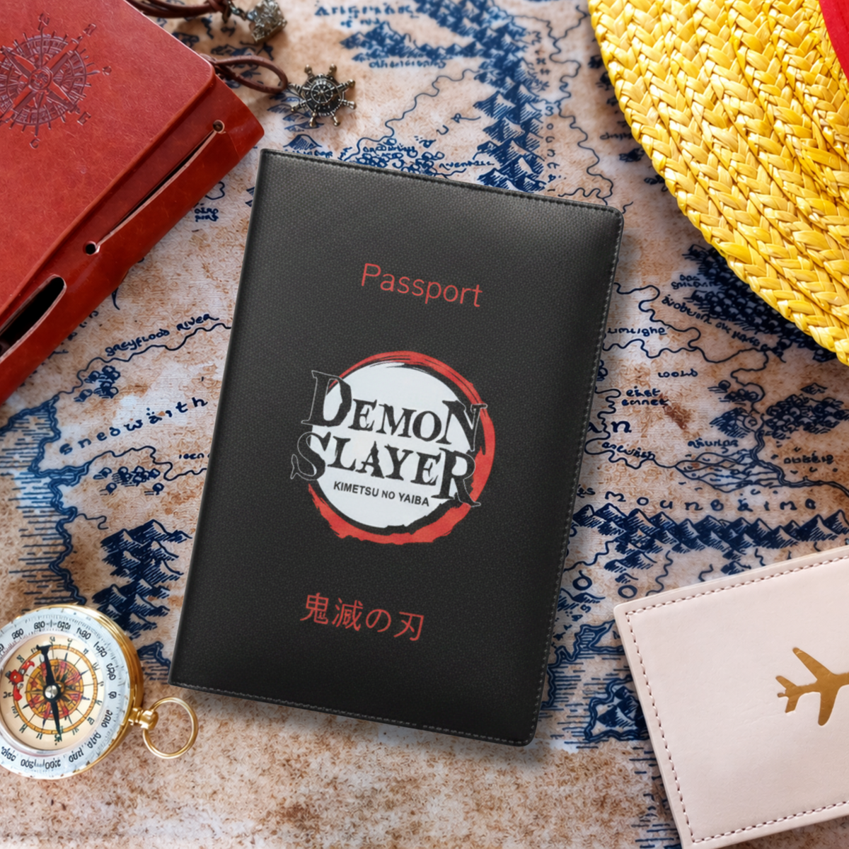 Black 'Demon Slayer' passport holder on a map with travel items around